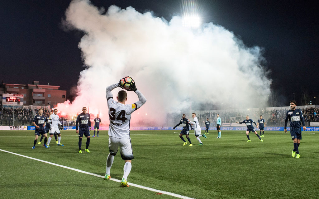 Fans ignite flares during a football match